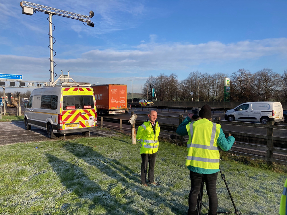 Acusensus’ Geoff Collins speaks to a BBC crew next to the M1 in England