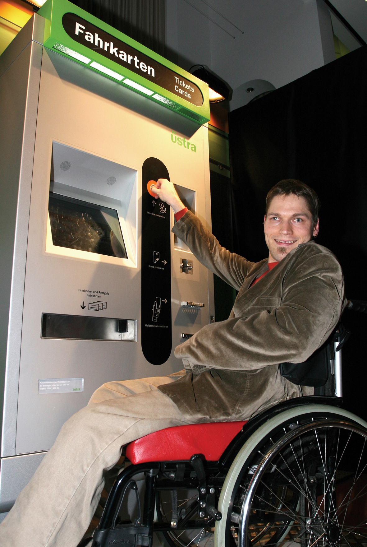 Wheelchair user using a ticket machine